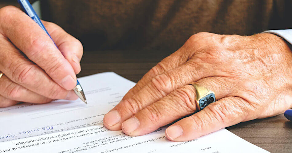 Hands of a man signing a contract