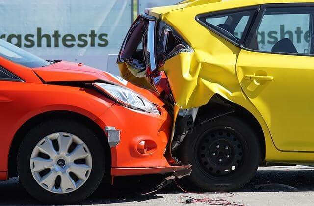 Red car in a rear-end collision with a yellow car
