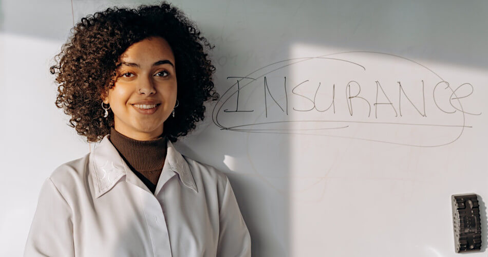 Woman next to whiteboard with word insurance written on it, about to give presentation