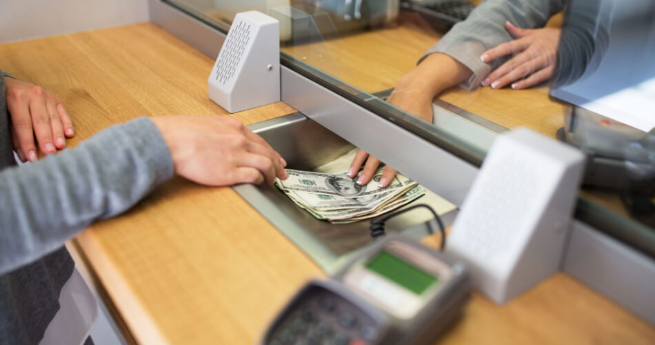 Bank teller giving money to a customer