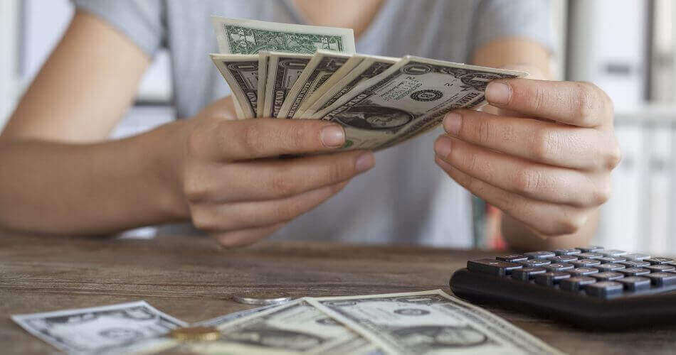 Woman counting dollar bills in her hands