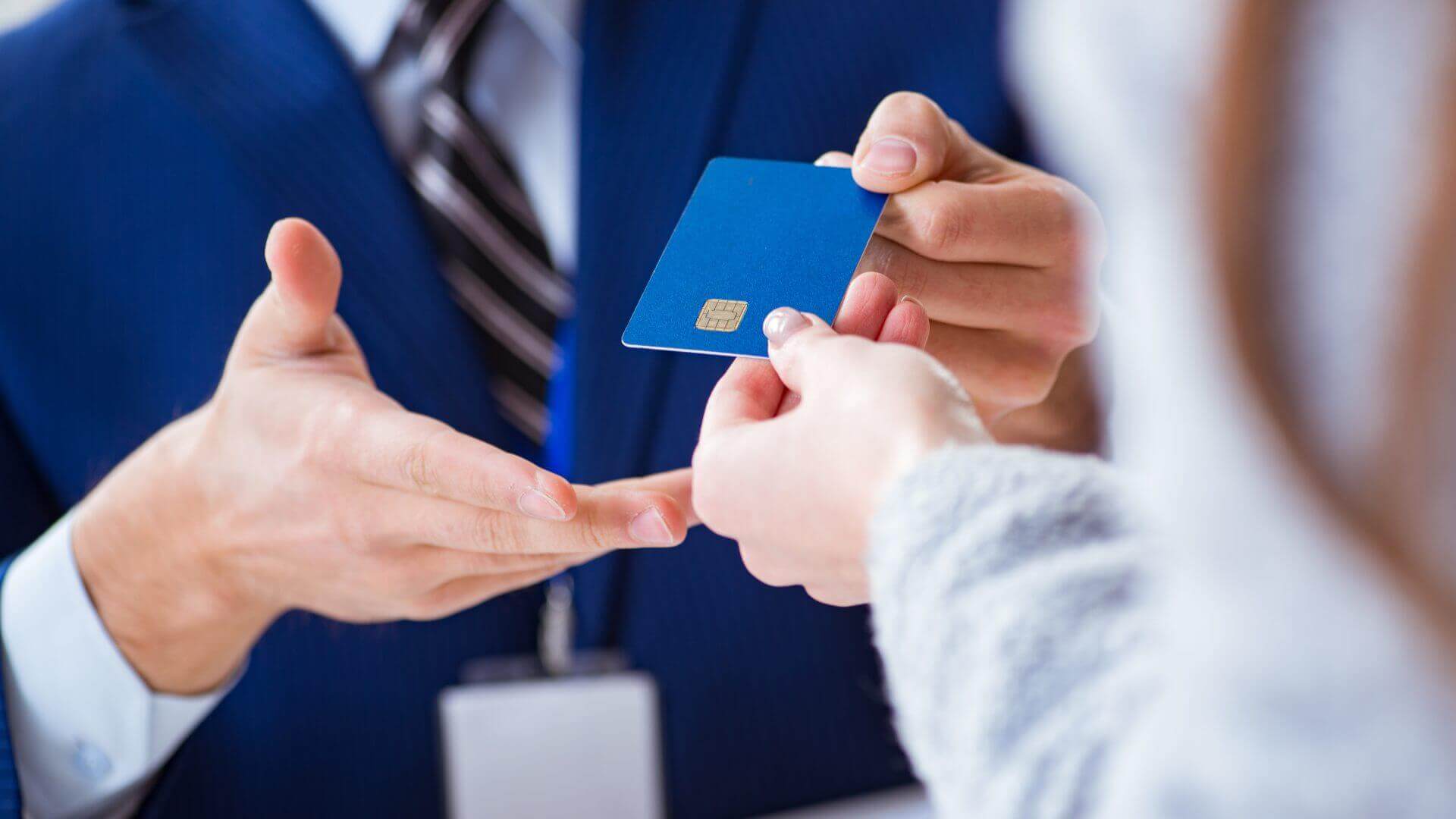 Person handing over a Amex or Chase credit card that has concierge services