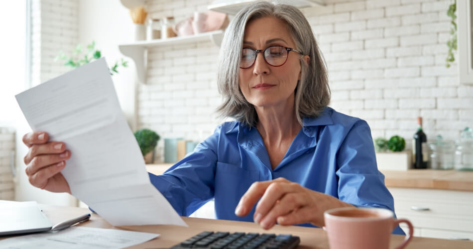 Woman reviewing her budget and calculating how much $82k/year an hour would equal