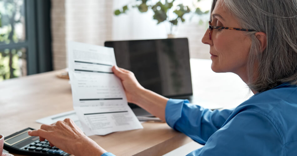 Woman reviewing her financial statements to determine whether purchasing an annuity is worth it