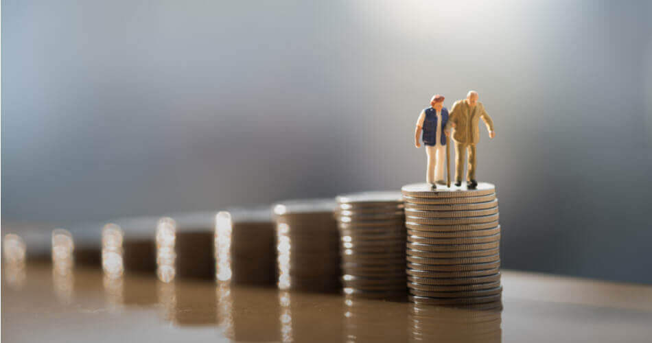 Figures of an elderly couple standing on top of coin stacks, representing CD interest income