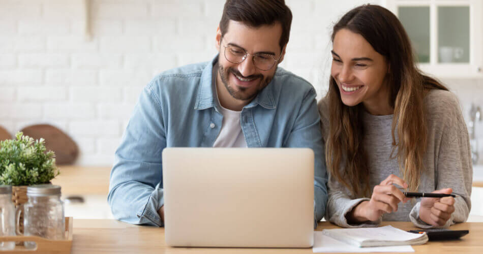 Couple smiling upon learning how to get late payments removed from their credit reports