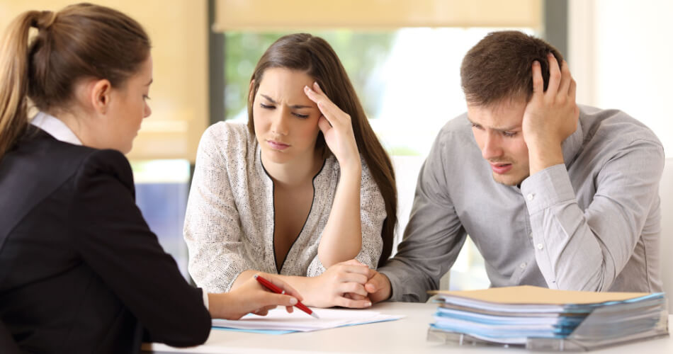 Couple looking worried as they discover they were victims of home title theft