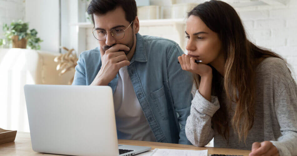 Couple reviewing their finances to figure out how they can become financially independent