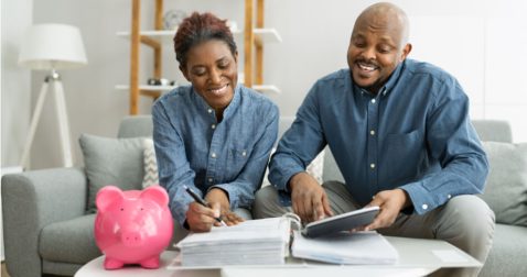 Smiling couple comparing documents from countries with no income tax