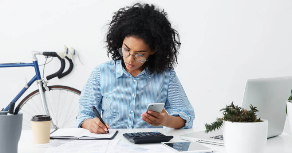 Young woman calculating how much she could earn on interest from rising CD rates